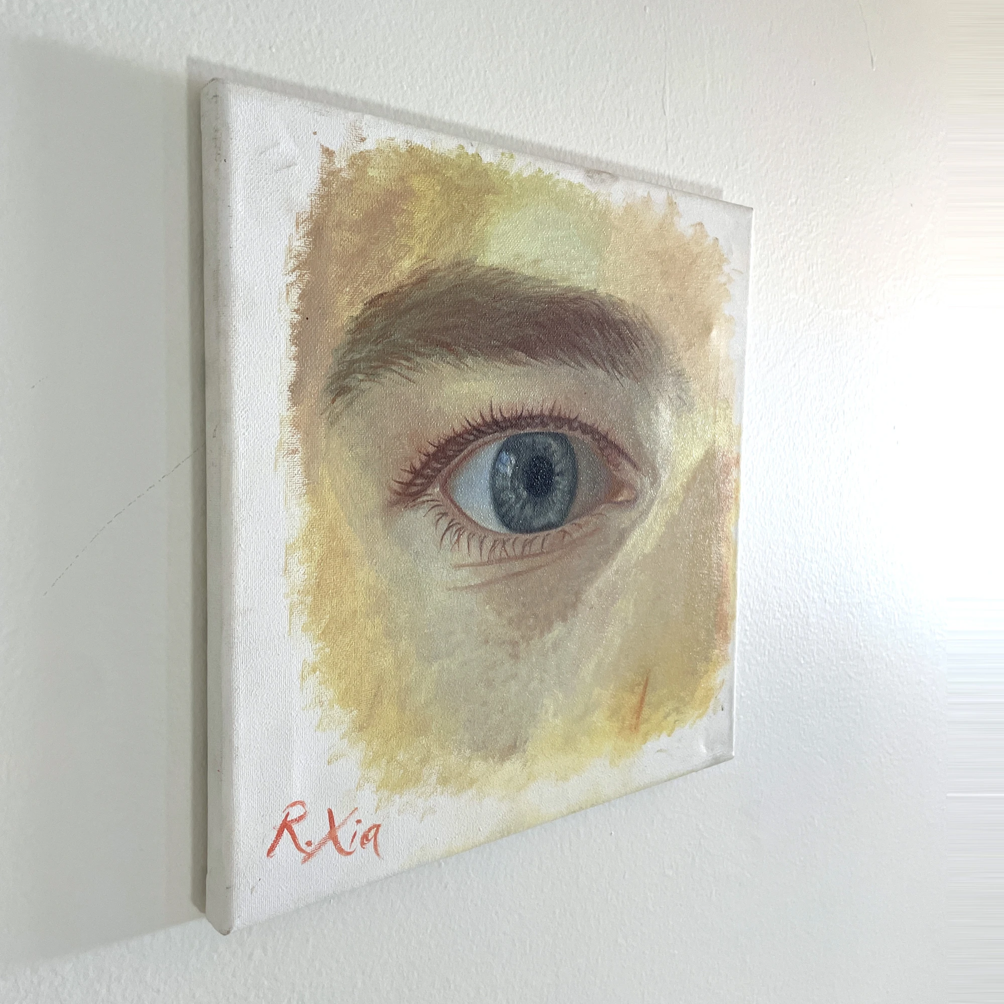 The painting seen at a three-quarter angle, showing the canvas and paint surface